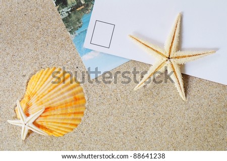postcard on sand with a lot of beach items