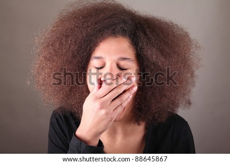 beautiful afro woman in front of a dark background