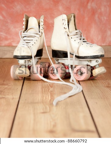roller skates on a wood background