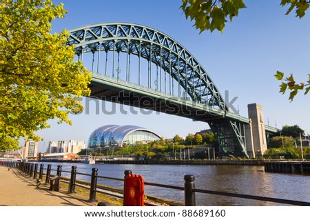 Tyne bridge framed with leaves / View of the iconic Tyne bridge with Gateshead Sage below it Royalty-Free Stock Photo #88689160