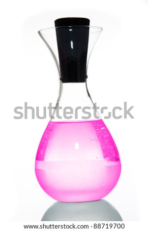 bottle filled with pink liquid with bubbles