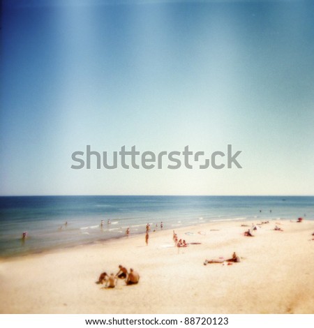 Designed retro photo. Sunny day on the beach. Grain, dust, colors added as vintage effect.