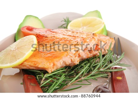 healthy food: hot baked salmon piece served over glass plate isolated on white background