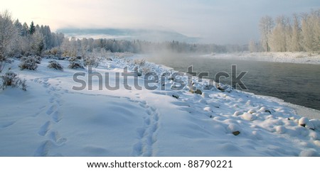 Winter landscape with snow trees and river in mountains