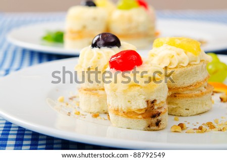 Plate full of tasty mini cakes