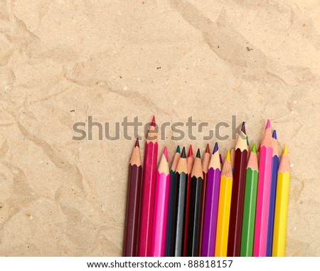 old paper sheet and stack of colored pencils