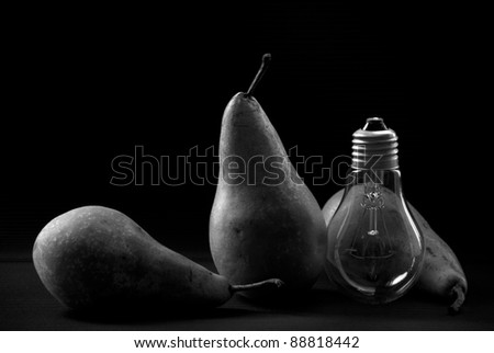Still life series: pears and electric bulb. Black and white photography, low key
