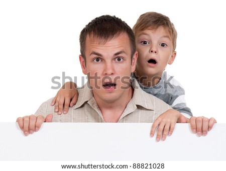 Portrait of happy dad and son with empty white board isolated on white background