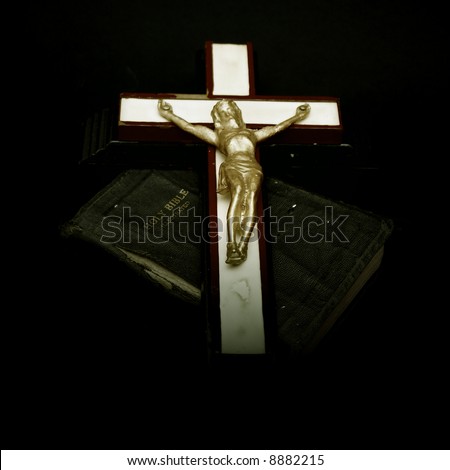 full color image of an old crucifix laying on top of an ancient leatherbound bible
