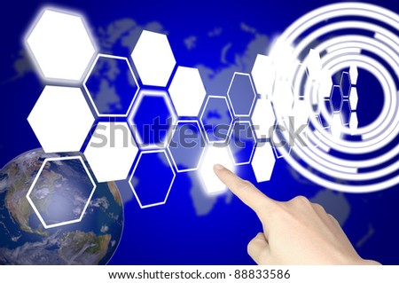Hand of business man press hexagon button on world map or tablet pc touch screen