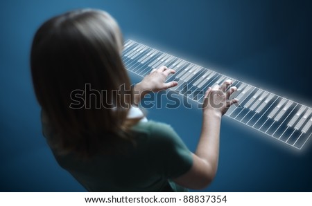 Young girl playing music on virtual piano keyboard