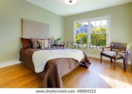 Modern fresh bedroom with oak floor and browns bedding