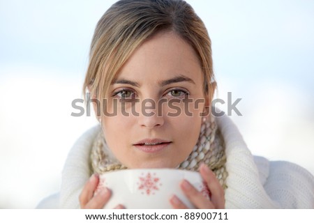 Woman drinking from large mug of coffee
