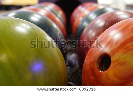 several multicolored balls for playing bowling