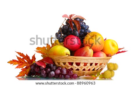 beautiful autumn harvest in basket and leaves isolated on white