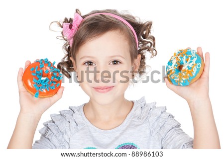 Picture of funny little girl with colorful donuts on white background