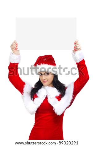 Beautiful woman dressed in santa claus holding a blank board
