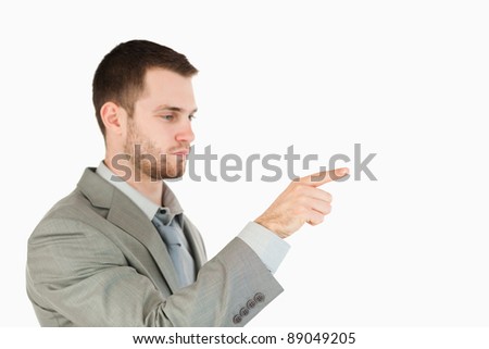 Side view of businessman using futuristic touch screen against a white background