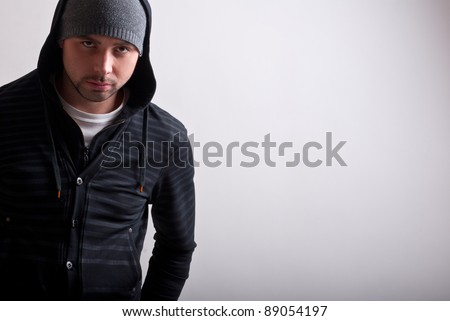 Closeup of a hooded teenager looking menacing
