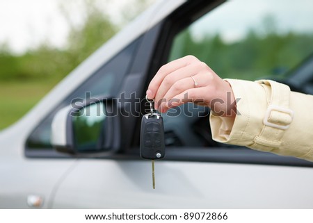 Hand showing keys out the car window