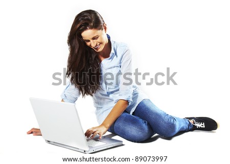 portrait of a beautiful young woman with laptop standing on floor