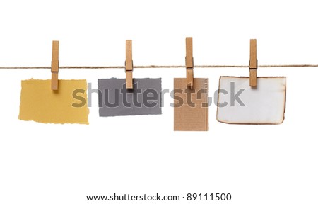 close up of  a notes and a clothes pegs on white background