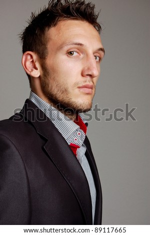 portrait of a young businessman on gray background