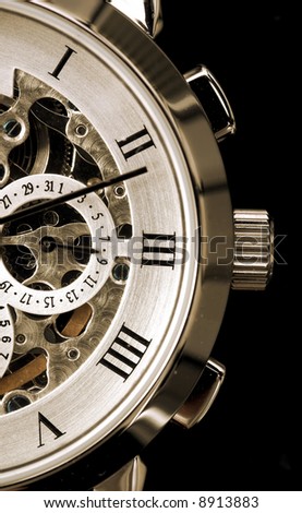 Gentleman’s watch, with exposed mechanism showing wheels and cogs Royalty-Free Stock Photo #8913883