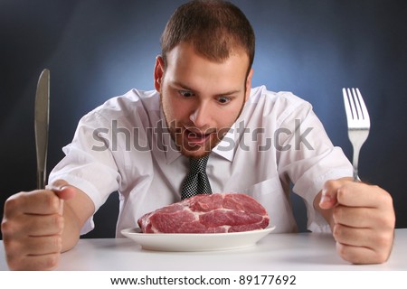 eccentric guy eating red meat Royalty-Free Stock Photo #89177692