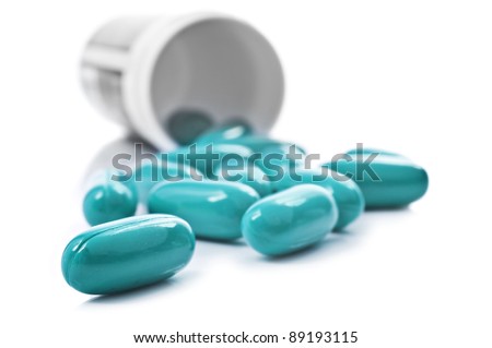 Blue pills an pill bottle on white background Royalty-Free Stock Photo #89193115