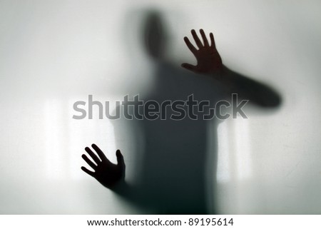 Shadowy figure behind glass Royalty-Free Stock Photo #89195614