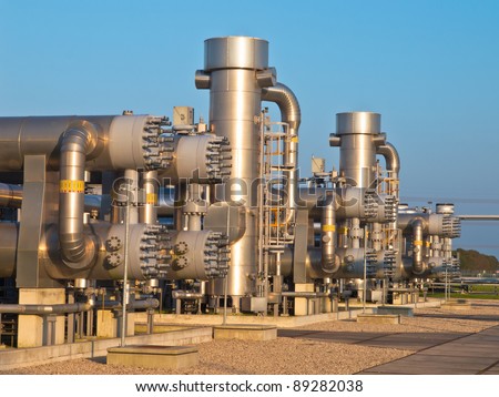 Natural gas processing site during sunset. Modern equipment is used to mine the last remainder from the field. Royalty-Free Stock Photo #89282038