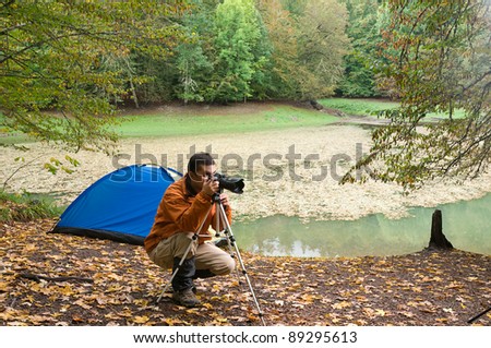 Wildlife photographer taking pictures outdoors during hiking trip