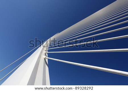 Modern bridge pylon against a blue sky Royalty-Free Stock Photo #89328292