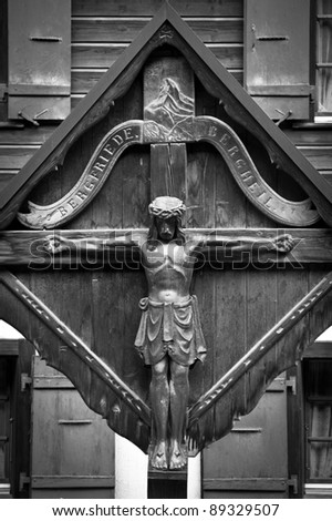 Wooden cross with Jesus in Zermatt, Switzerland (b&w picture)