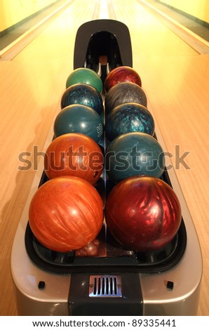 Colorful bowling balls in container