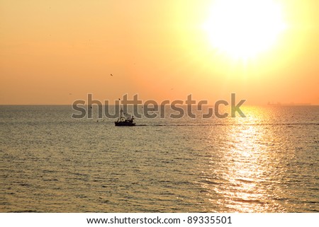 Fishing boat at sunset in Greece