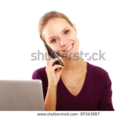 A young woman with a laptop talking on the phone isolated on white background