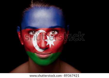 Portrait of a woman with the flag of the Azerbaijan painted on her face.