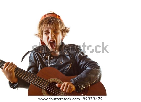 Cute small kid playing guitar with great concentration and attitude. White background, plenty of copy space. Royalty-Free Stock Photo #89373679