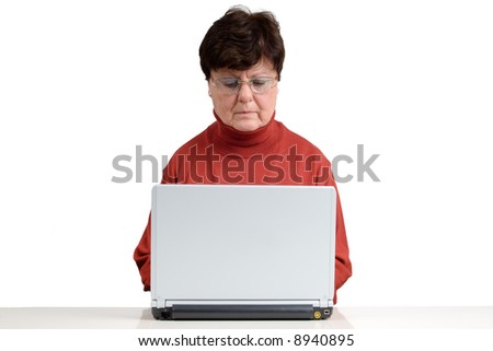 Senior woman in front of a computer. Studio picture. Full isolated.