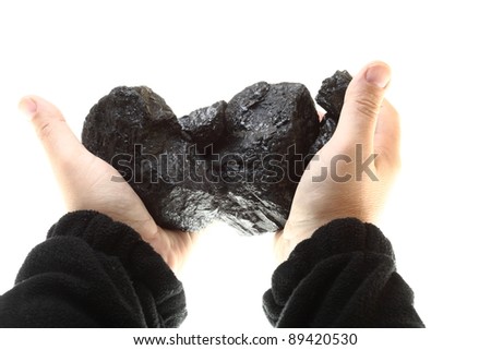 Pieces of coal in hand isolated on white background