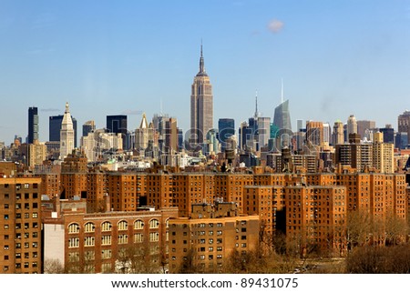 A picture of New York City, NY, USA, featuring the skyline of midtown with the famous Empire State Building in the center.