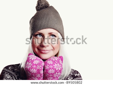 girl in a hat and mittens in the winter on a white background