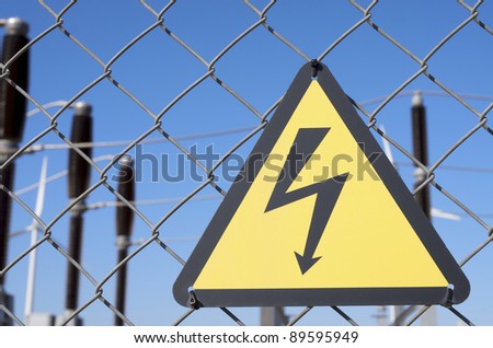 electrical hazard sign placed on a metal fence