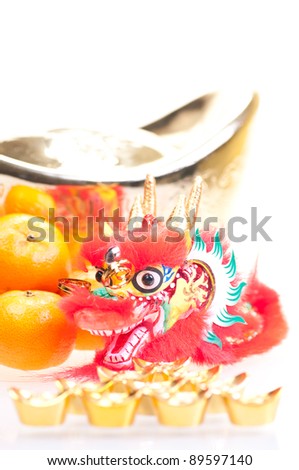 Chinese new year with dragon decoration, large gold ingot and mandarin oranges