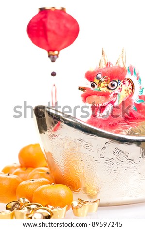 Chinese new year with dragon decoration, large gold ingot,red lantern and mandarin oranges