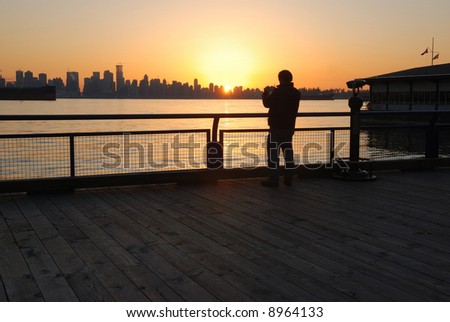 man taking photos at sunset