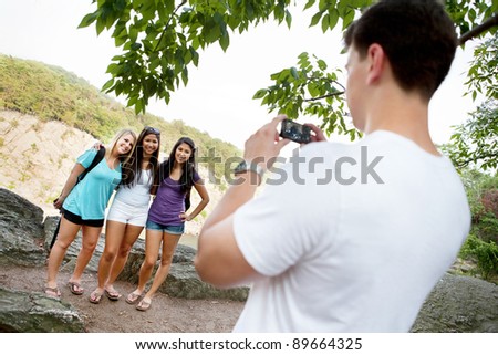 Young man taking pictures of young ladies on a hike at Great Falls National Park in Virginia