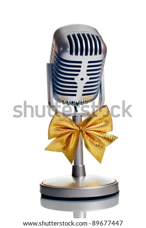 Classic microphone with golden bow tie isolated over white